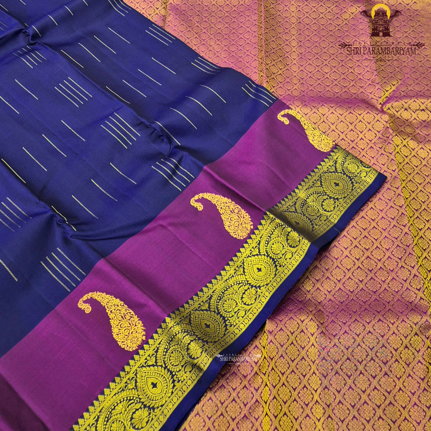 A rich royal blue body beautifully contrasted with a vibrant magenta Saree
