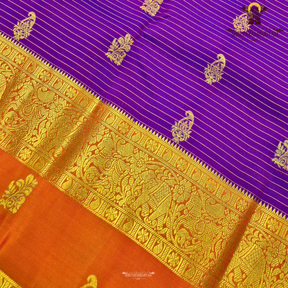 Deep royal purple body with rust orange contrast pallu and rich antique gold zari Saree