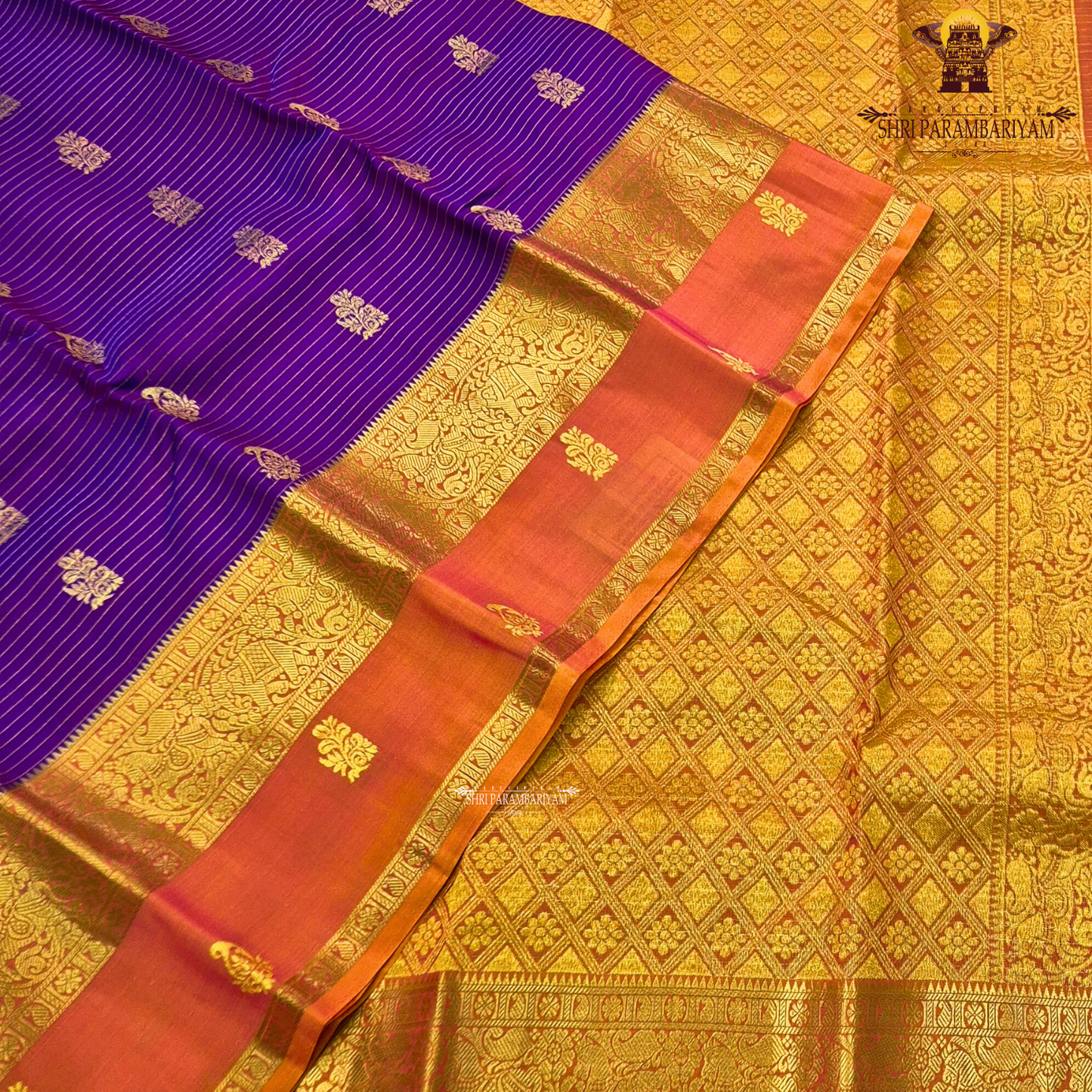 Deep royal purple body with rust orange contrast pallu and rich antique gold zari Saree