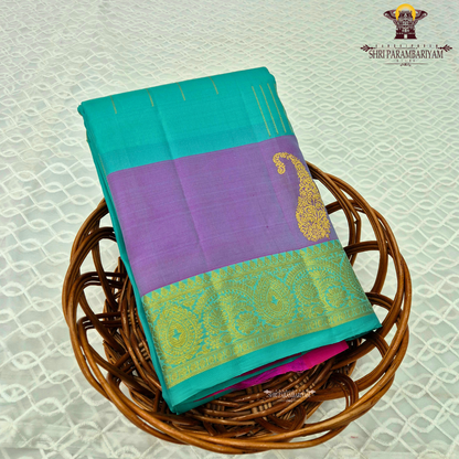 A refreshing turquoise green body paired with a soft lavender-purple contrast Saree