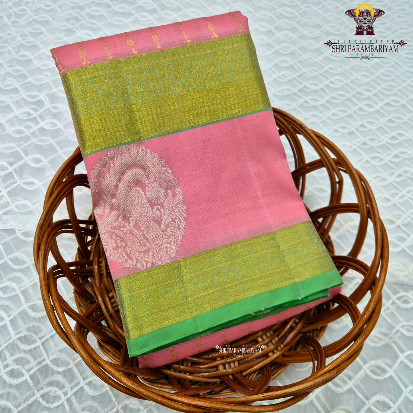 A graceful soft pink body complemented by a rich parrot green contrast border Saree