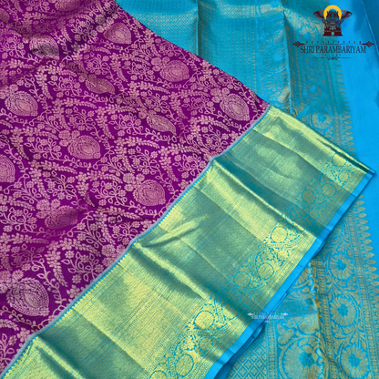 A rich violet purple body with a contrasting sky blue korvai border Saree
