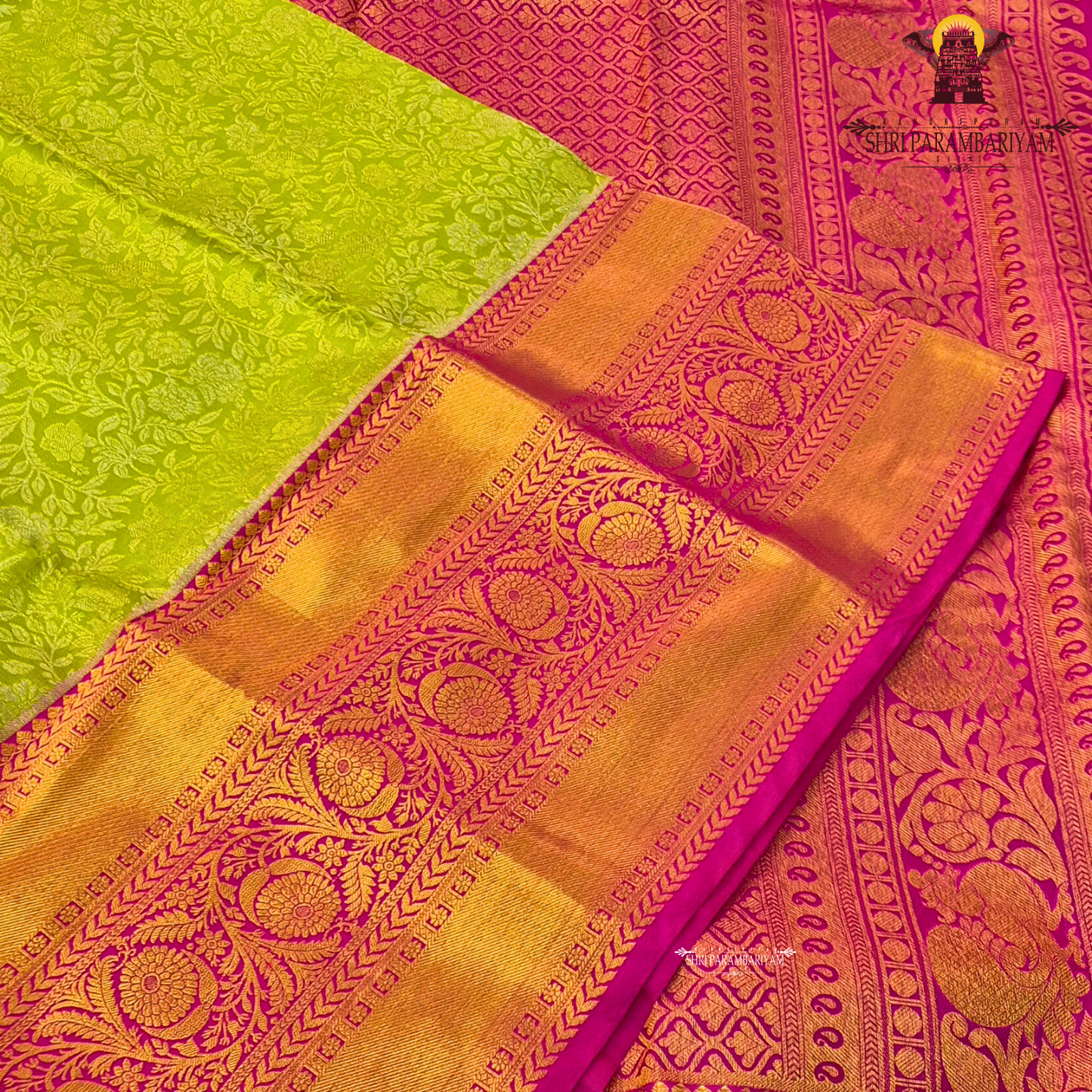 A refreshing parrot green body paired with a vibrant rani pink border Saree