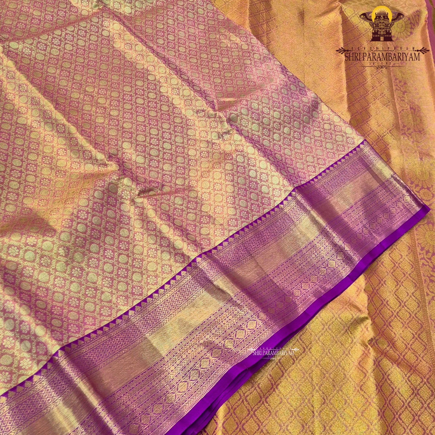 A Soft pastel peach with rich gold zari work and a contrasting deep magenta (rani pink) border Saree