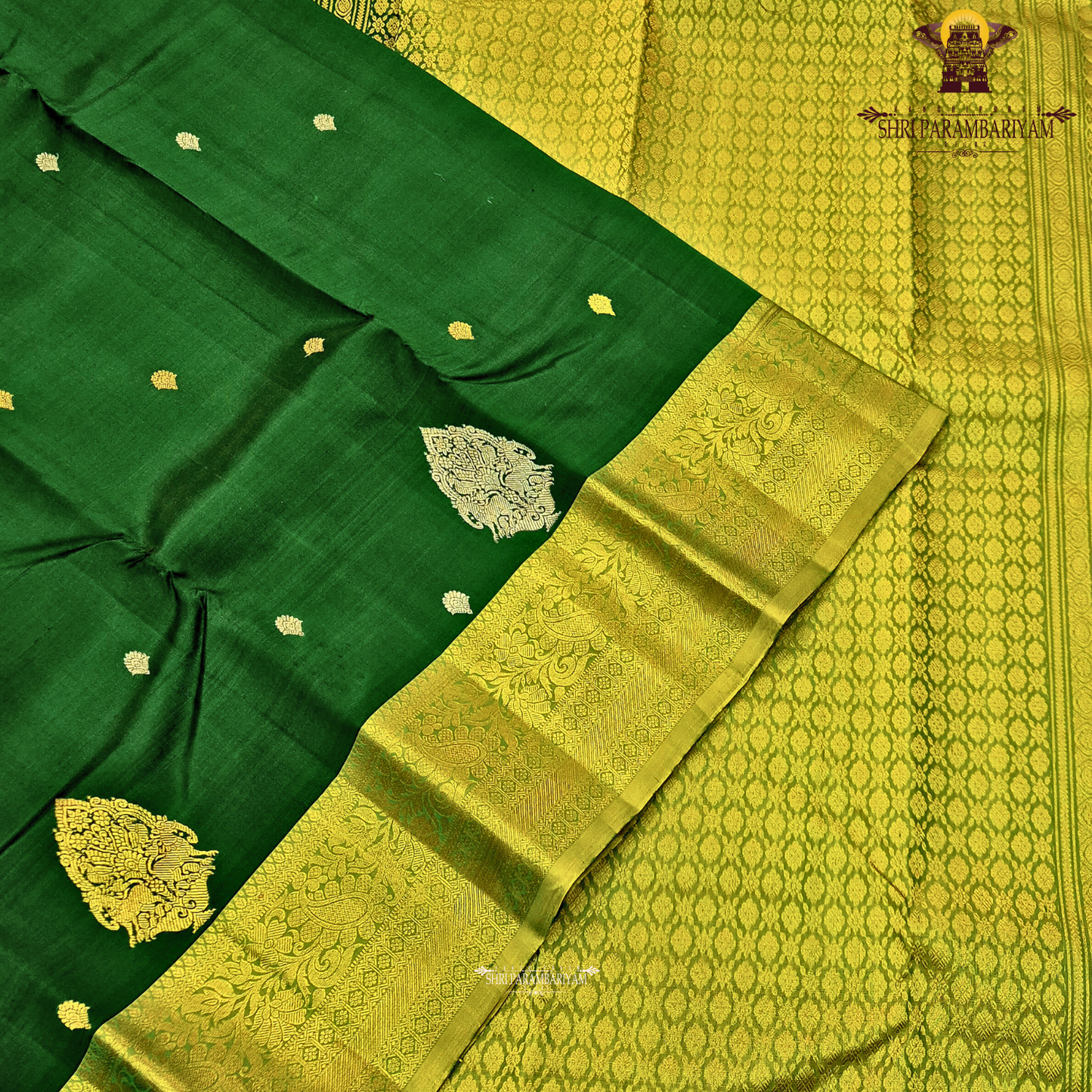 Rich bottle green with a contrasting antique gold zari border featuring a subtle olive-green tone Saree