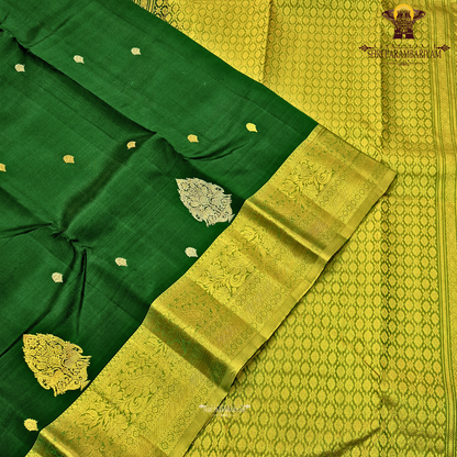 Rich bottle green with a contrasting antique gold zari border featuring a subtle olive-green tone Saree