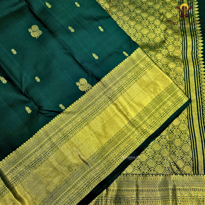 A captivating Deep Bottle Green / Dark Teal Green shade, beautifully complemented Saree