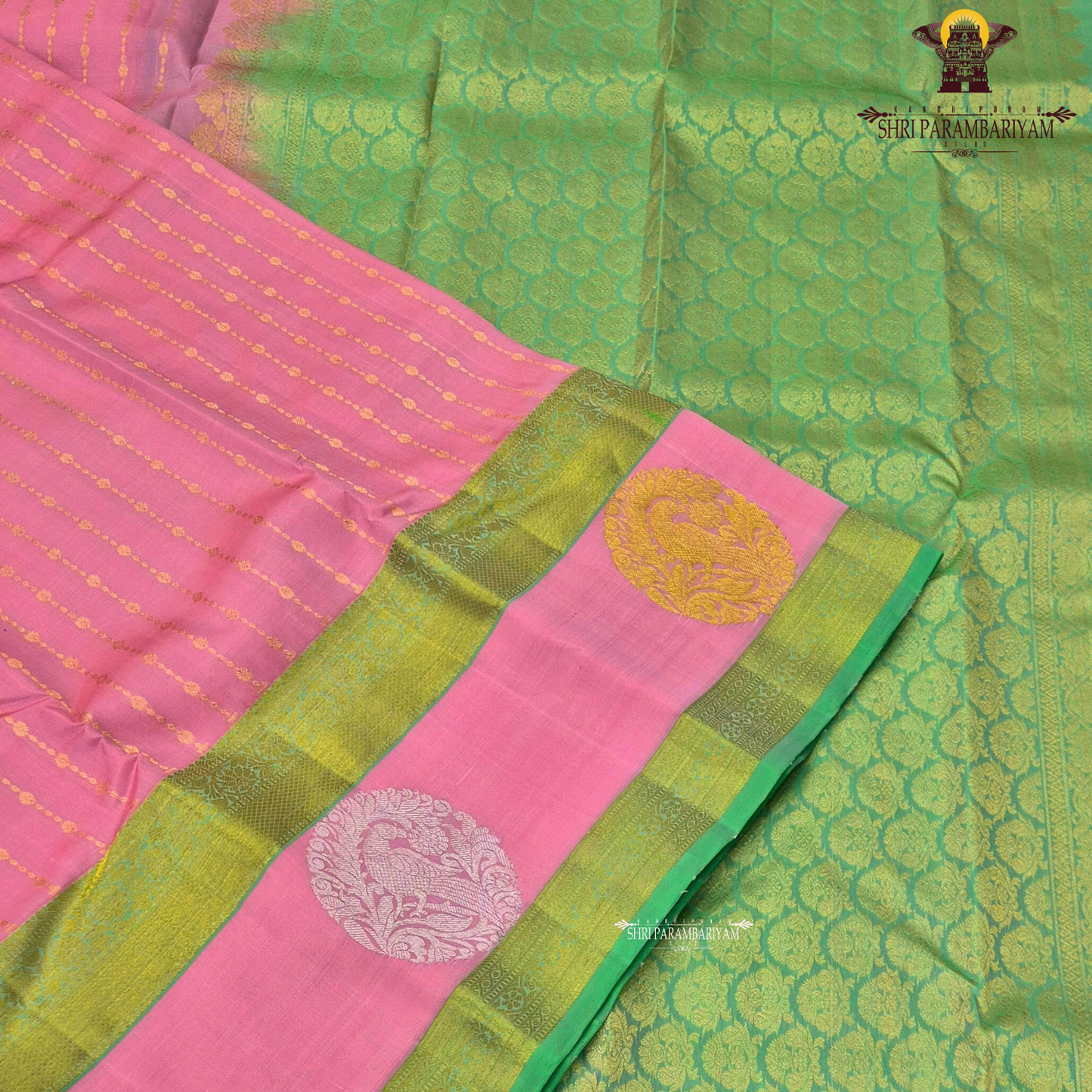 A graceful soft pink body complemented by a rich parrot green contrast border Saree