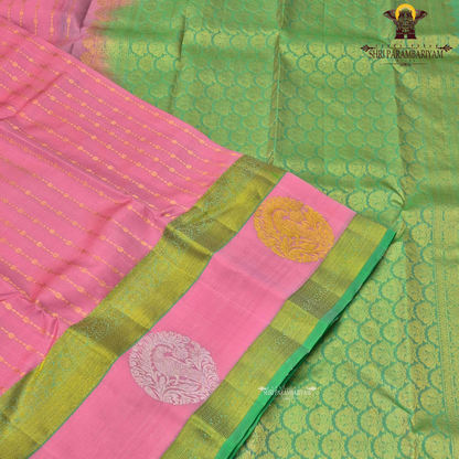 A graceful soft pink body complemented by a rich parrot green contrast border Saree
