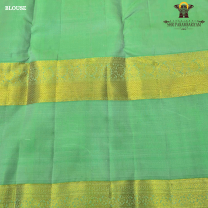 A graceful soft pink body complemented by a rich parrot green contrast border Saree