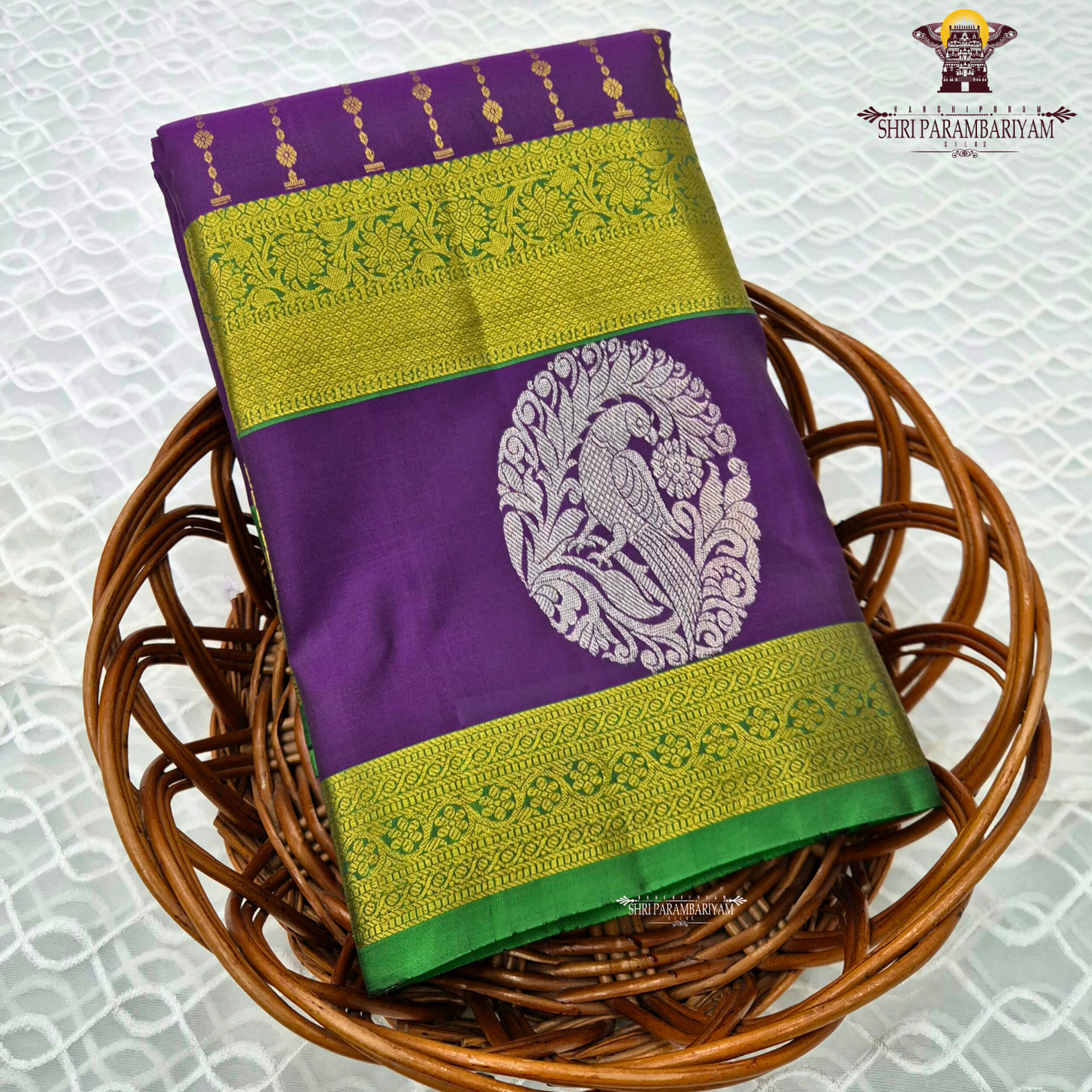 A rich royal purple body beautifully complemented by a vibrant parrot green contrast border Saree