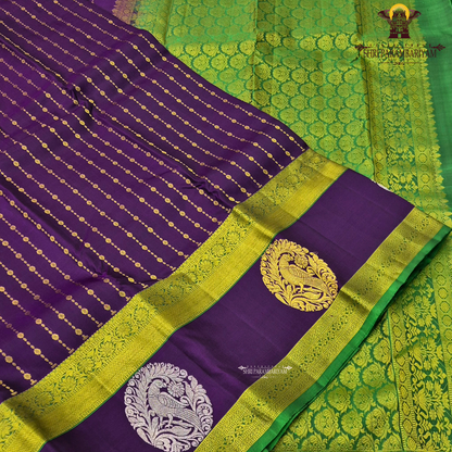 A rich royal purple body beautifully complemented by a vibrant parrot green contrast border Saree