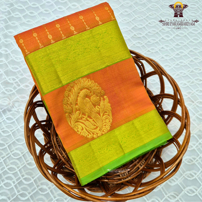 A vibrant orange body beautifully contrasted with a bright parrot green border Saree