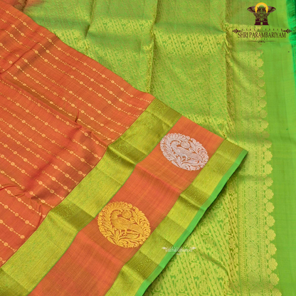 A vibrant orange body beautifully contrasted with a bright parrot green border Saree