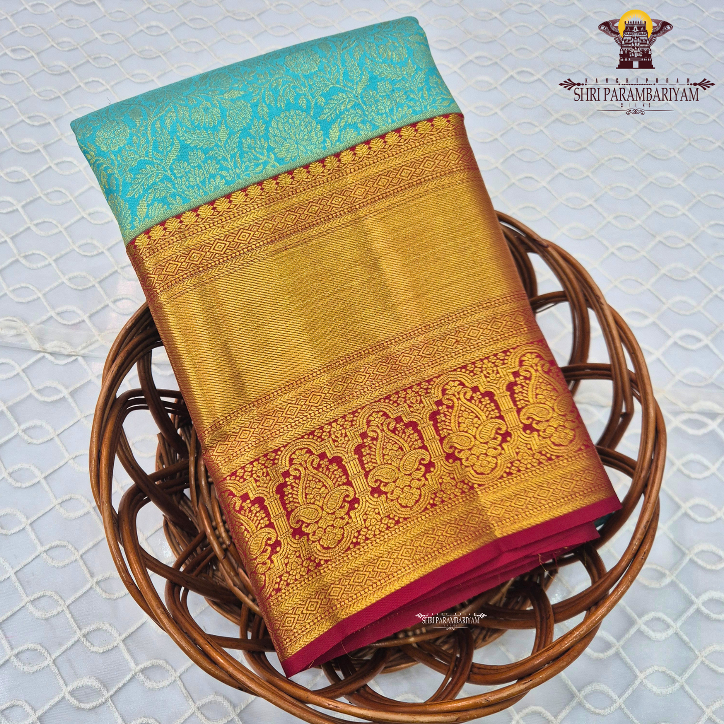 A beautiful aqua blue body with elegant floral zari weaving, paired with a rich golden Saree