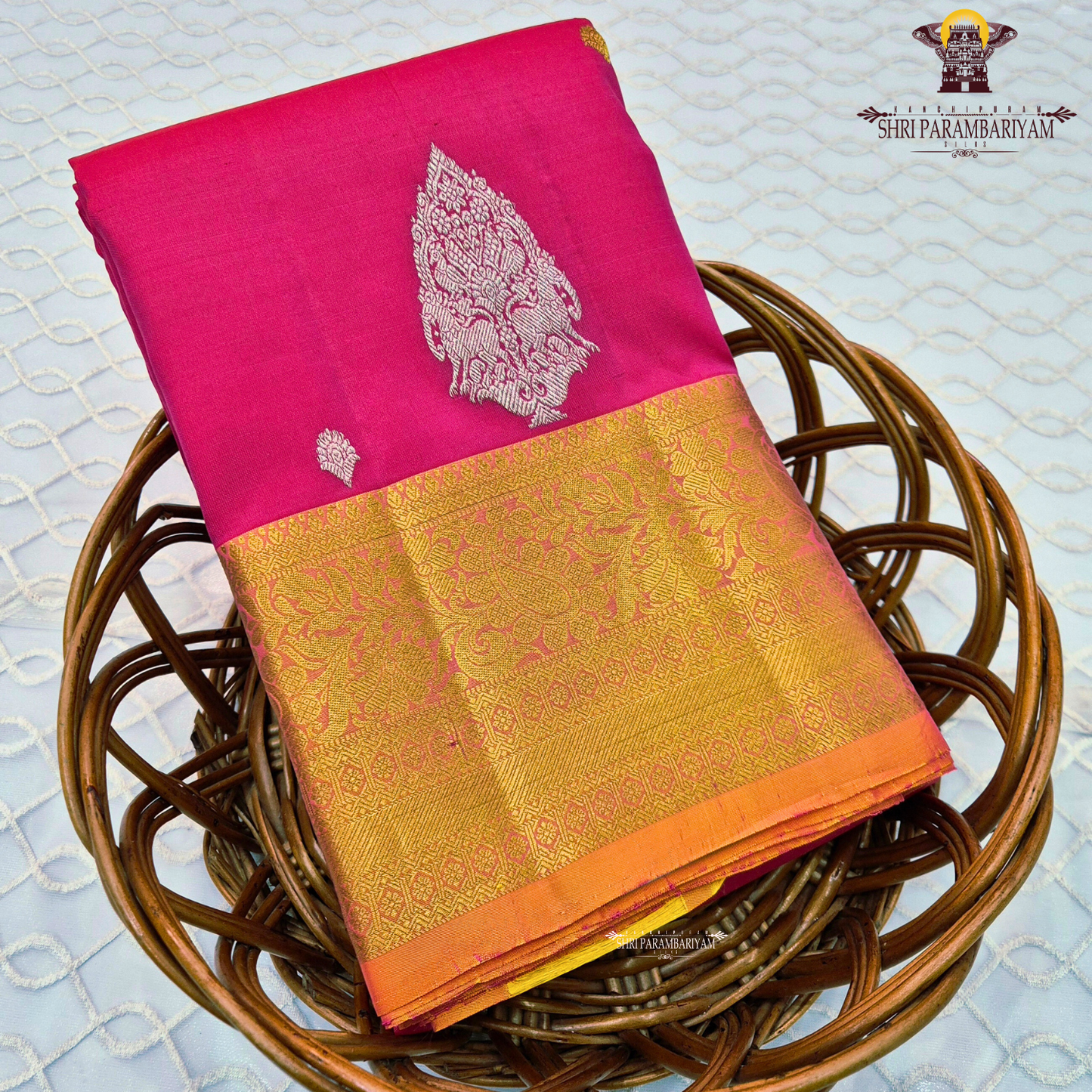 Bright rose pink (rani pink shade) with a rich gold zari border highlighted by a soft orange edging Saree