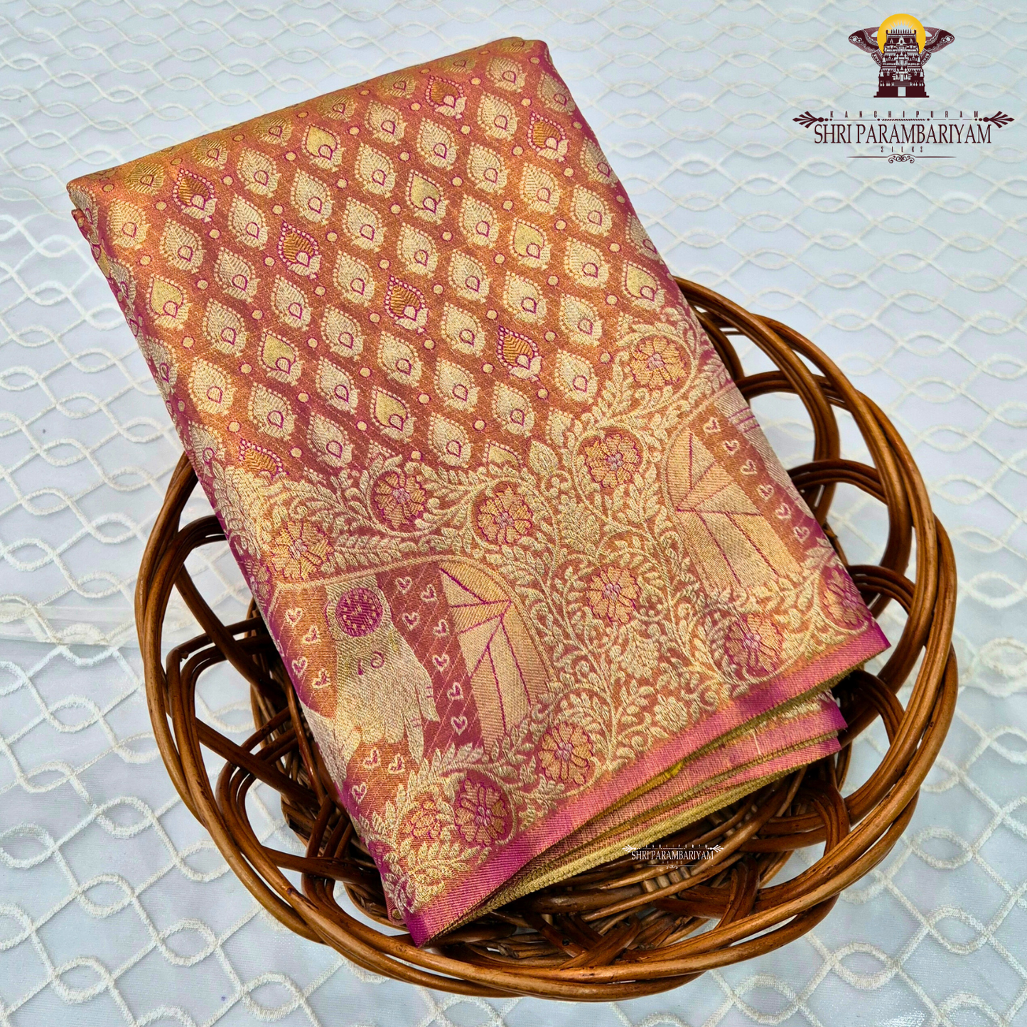 A shimmering copper-gold tissue base, giving the fabric a radiant and luxurious Saree