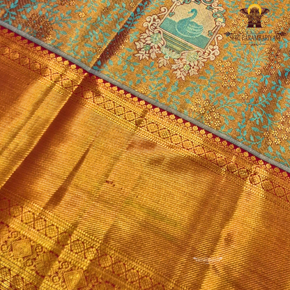 Rich dual-tone blend of antique gold and teal green Saree
