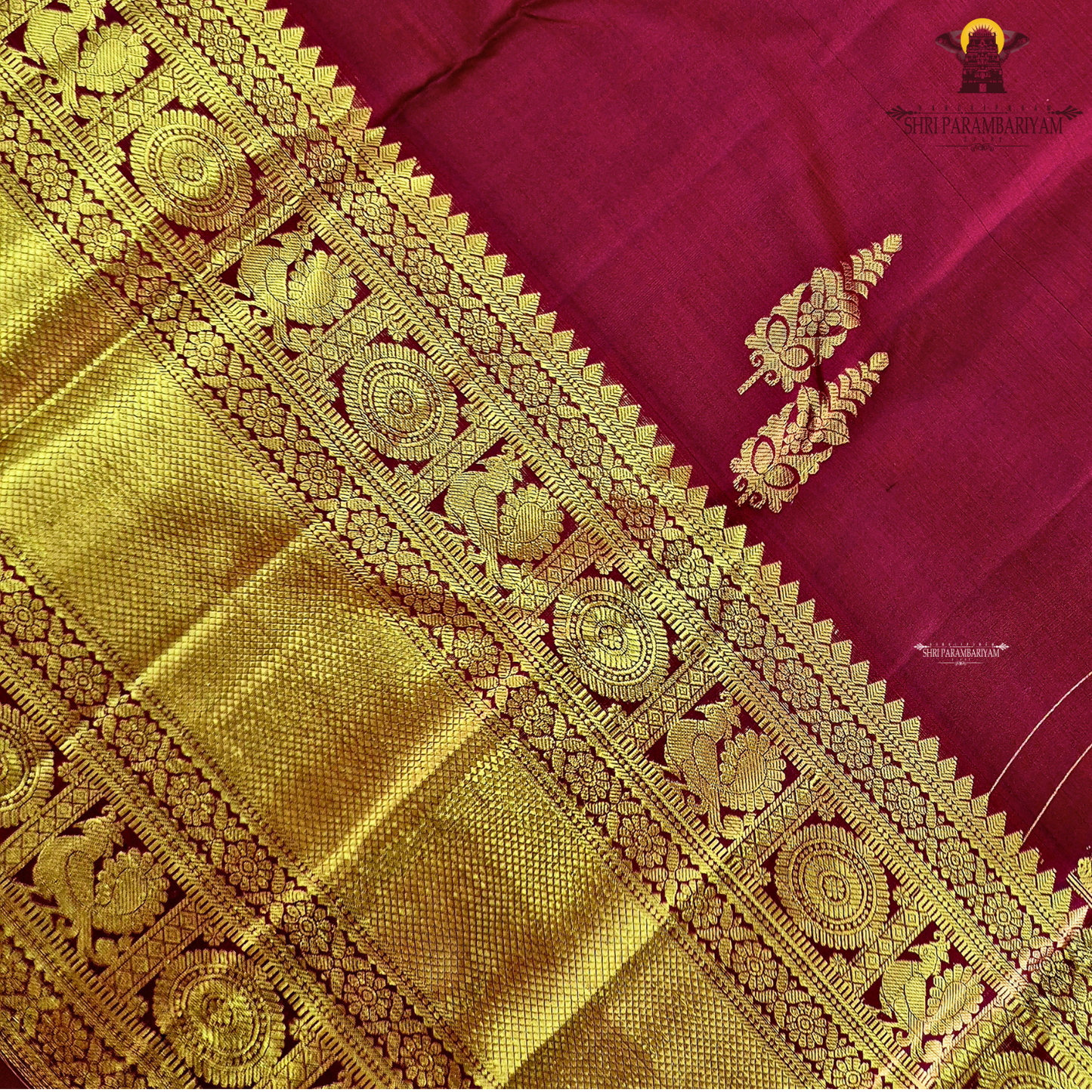 A rich maroon shade, beautifully adorned with elegant gold zari Saree