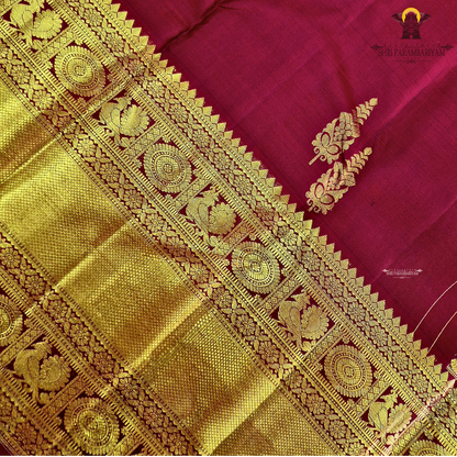 A rich maroon shade, beautifully adorned with elegant gold zari Saree