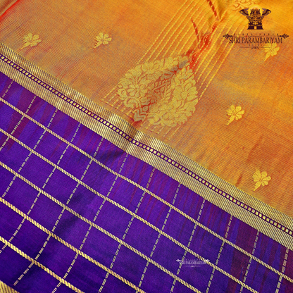 A rich mustard orange body paired beautifully with a deep royal purple pallu and border Saree