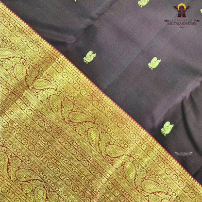 A luxurious deep black grape shade, adorned with delicate gold zari Saree