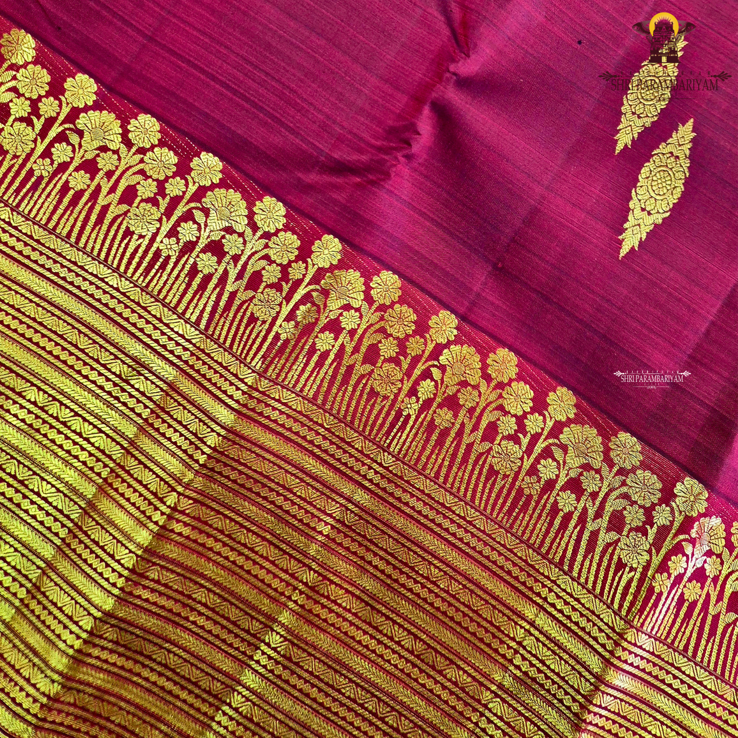 A vibrant Ruby Red shade, elegantly adorned with traditional gold zari buttas Saree