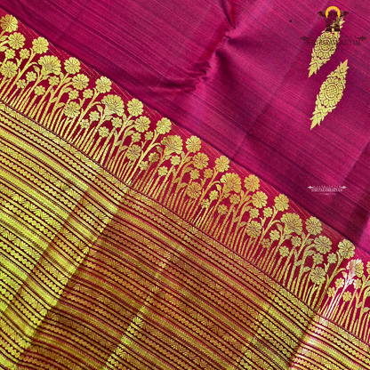A vibrant Ruby Red shade, elegantly adorned with traditional gold zari buttas Saree