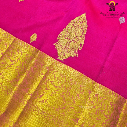 Bright rose pink (rani pink shade) with a rich gold zari border highlighted by a soft orange edging Saree
