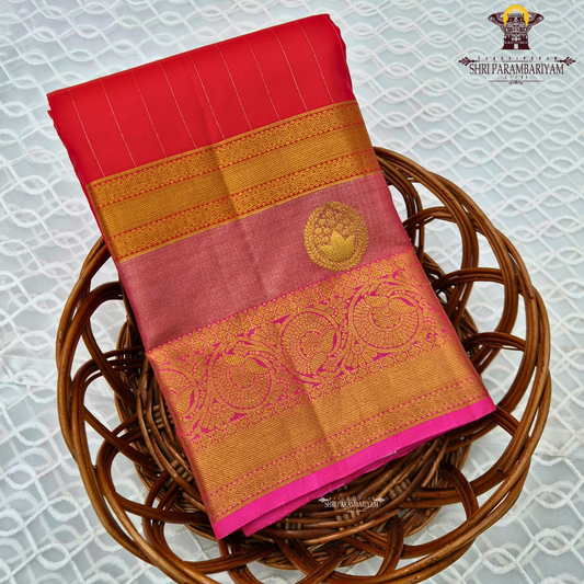 A vibrant reddish pink (vermilion red) body beautifully complemented Saree
