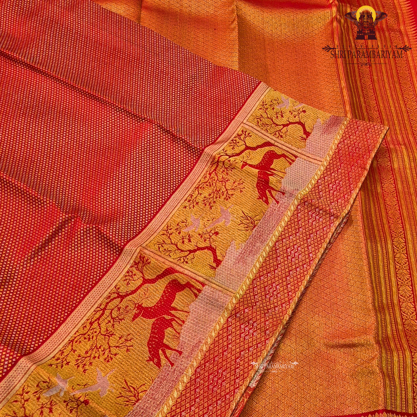 A vibrant bridal red color complemented by rich gold zari weaving Saree