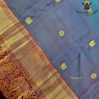 A rich dual-tone blend of deep peacock blue and violet (iridescent shade) body with a contrast Saree