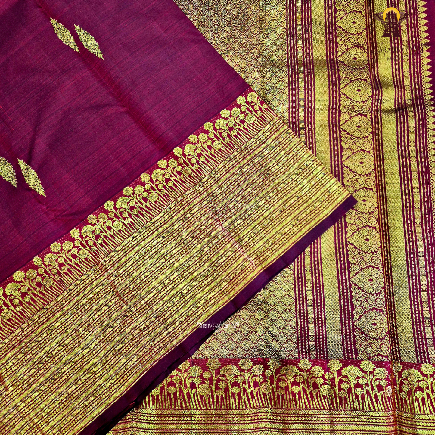 A vibrant Ruby Red shade, elegantly adorned with traditional gold zari buttas Saree
