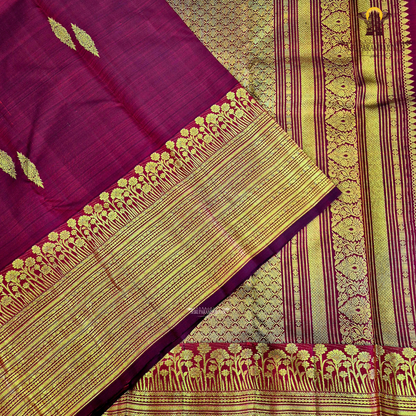 A vibrant Ruby Red shade, elegantly adorned with traditional gold zari buttas Saree
