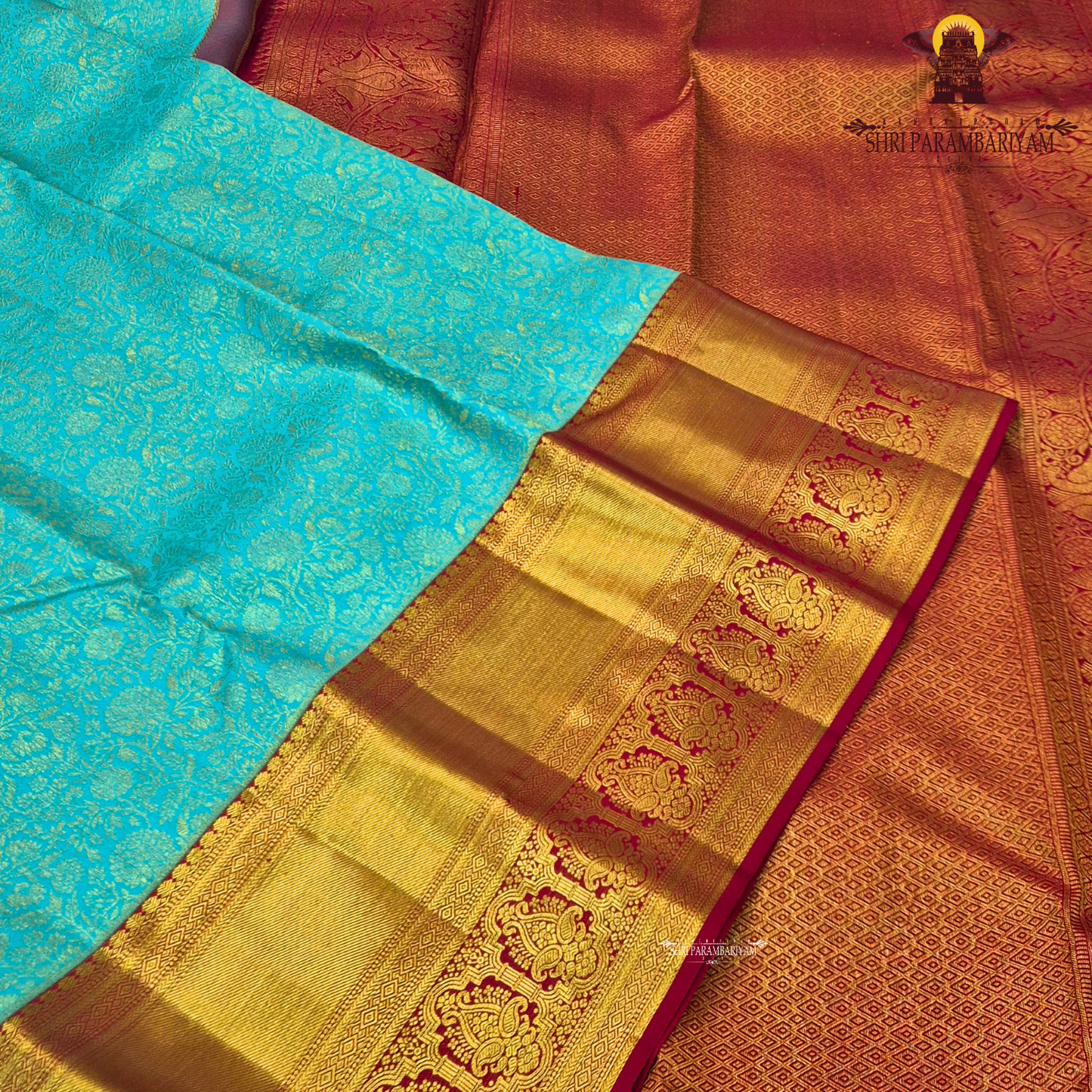 A beautiful aqua blue body with elegant floral zari weaving, paired with a rich golden Saree