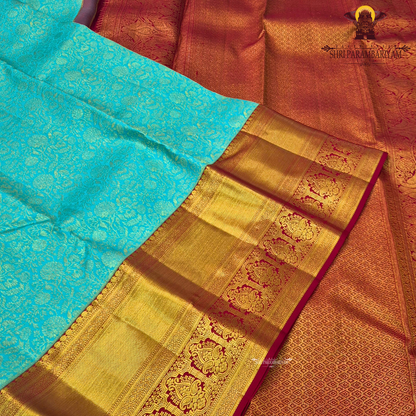 A beautiful aqua blue body with elegant floral zari weaving, paired with a rich golden Saree