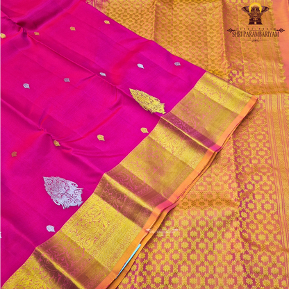 Bright rose pink (rani pink shade) with a rich gold zari border highlighted by a soft orange edging Saree