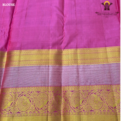 A vibrant reddish pink (vermilion red) body beautifully complemented Saree