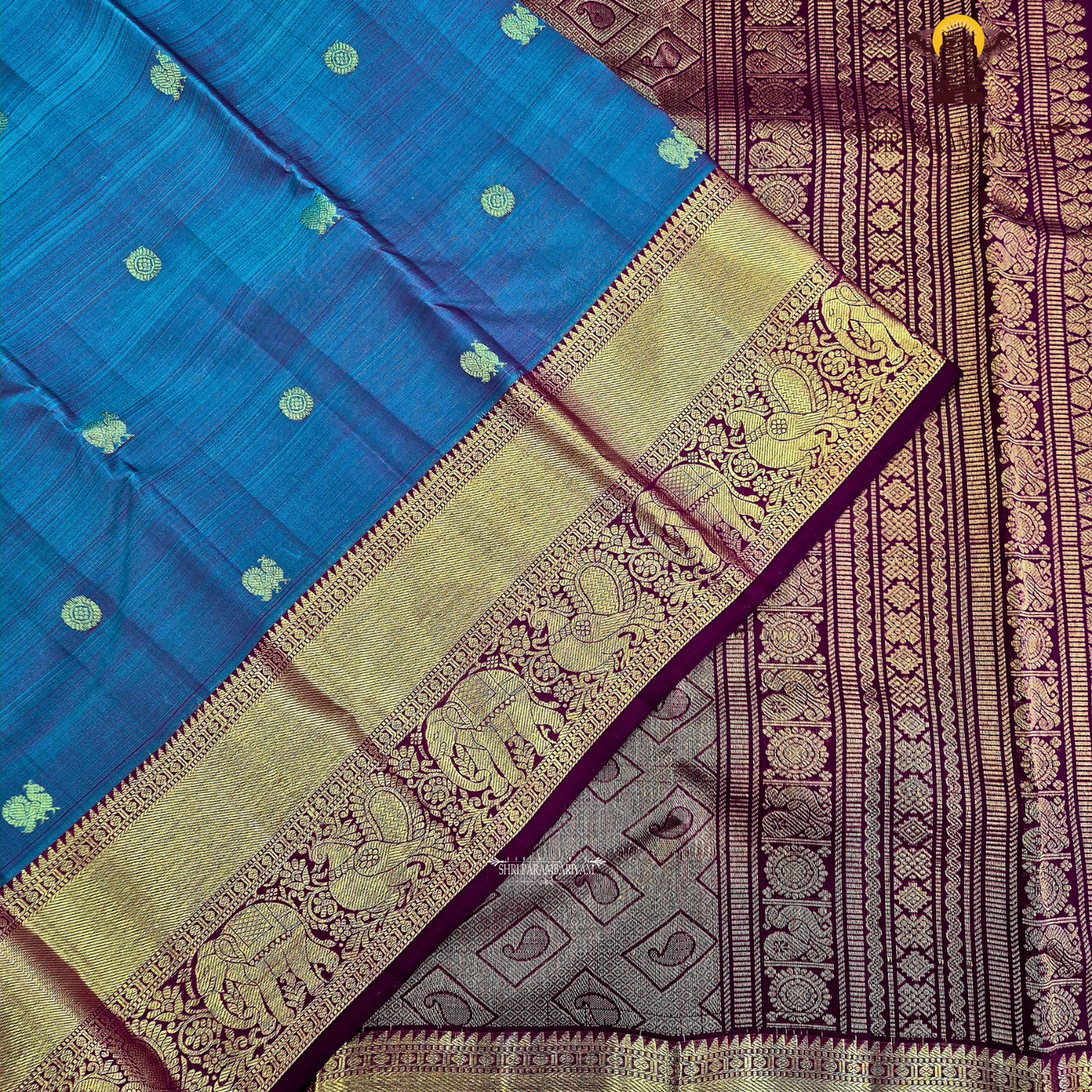 A rich dual-tone blend of deep peacock blue and violet (iridescent shade) body with a contrast Saree