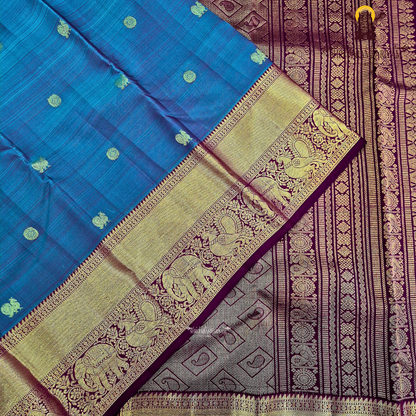 A rich dual-tone blend of deep peacock blue and violet (iridescent shade) body with a contrast Saree