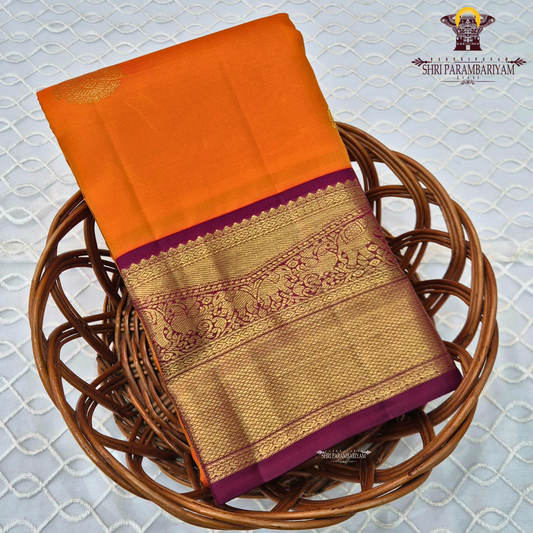 A bright and striking orange body adorned with a subtle Saree