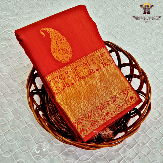 A radiant Vermilion Orange shade, beautifully highlighted with an exquisite gold zari Saree