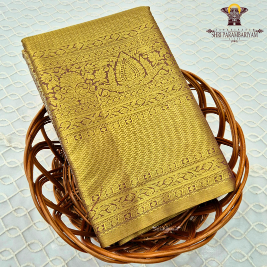 A rich antique gold body with a subtle dual-tone brown undertone Saree