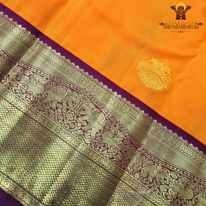 A bright and striking orange body adorned with a subtle Saree