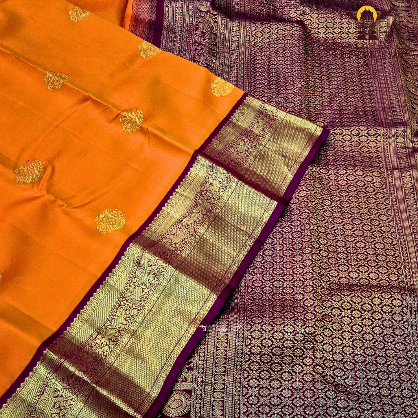 A bright and striking orange body adorned with a subtle Saree