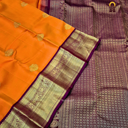 A bright and striking orange body adorned with a subtle Saree