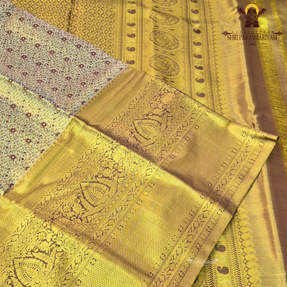 A rich antique gold body with a subtle dual-tone brown undertone Saree
