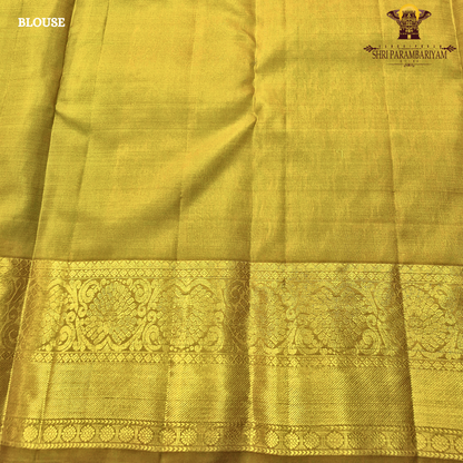 Rich teal green (peacock green tone) with a contrast gold zari border featuring a parrot green shade Saree