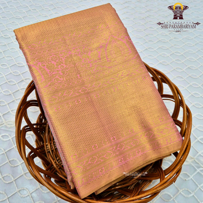 A rich golden tissue base with a soft peachy-pink undertone Saree
