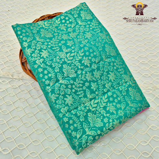 A vibrant peacock green / teal green base with elegant light gold zari work Saree